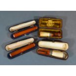 An Amber Yellow Metal Mounted Cheroot with case together with another similar together with two