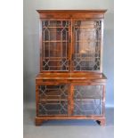 An Edwardian Mahogany Display Cabinet, the moulded cornice above two astragal glazed doors enclosing