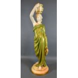 A Royal Worcester Porcelain Figure 'The Water Carrier' puce mark to base and numbered 125, 51 cms