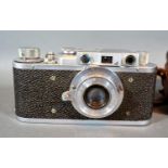 An FED Russian Soviet 50mm Camera No. 86321 together with a Leica leather camera case
