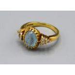 An 18ct. Gold Dress Ring with central cabochon moon stone flanked by six diamonds, claw set, ring