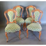 A Set of Four Victorian Drawing Room Side Chairs with partly upholstered and carved pierced backs