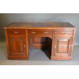 An Edwardian Twin Pedestal Desk with three drawers and two cupboard doors with brass handles