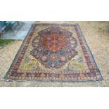 A North West Persian Woollen Carpet with a central medallion within an all-over design upon an