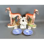A Pair of Staffordshire Models of Greyhounds together with a Staffordshire group, a pair of small