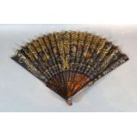 A Tortoiseshell and Black Gauze Fan with gilded decorated tortoiseshell sticks and guards and