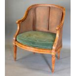 A Late 19th Century French Fauteuil, the cane back and sides with scroll arms raised upon turned