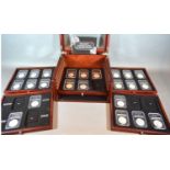 A Collection of 23 US Silver Dollars within collectors' box of five drawers