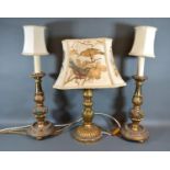 A Pair of Gilded Table Lamps together with another similar