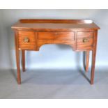 A Mahogany Bow Fronted Side Table with an arrangement of three drawers raised upon square tapering