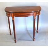 An Edwardian Mahogany Line inlaid Card Table with hinged reeded top above a shaped frieze, raised