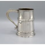 A London Silver Mug with shaped handle and waisted band Marked Harrods, 12oz, 12cm tall