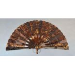 A Victorian Tortoiseshell Brise Fan with carved and pierced sticks and guards 20cm