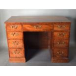 A 19th Century Mahogany Twin Pedestal Desk with an arrangement of nine drawers with brass handles,