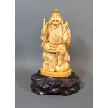 A 19th Century Japanese Carved Ivory Okimono in the form of a tradesman with hardwood stand 15cm