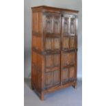 An Early 20th Century Oak Gothic Revival Hall Cupboard, the Gothic tracery and linen fold panel