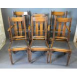 A Set of Six Early 20th Century Oak Dining Chairs comprising two arms and four singles each with