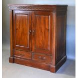 A 20th Century Hardwood Side Cabinet with two panel doors above two drawers raised upon a plinth