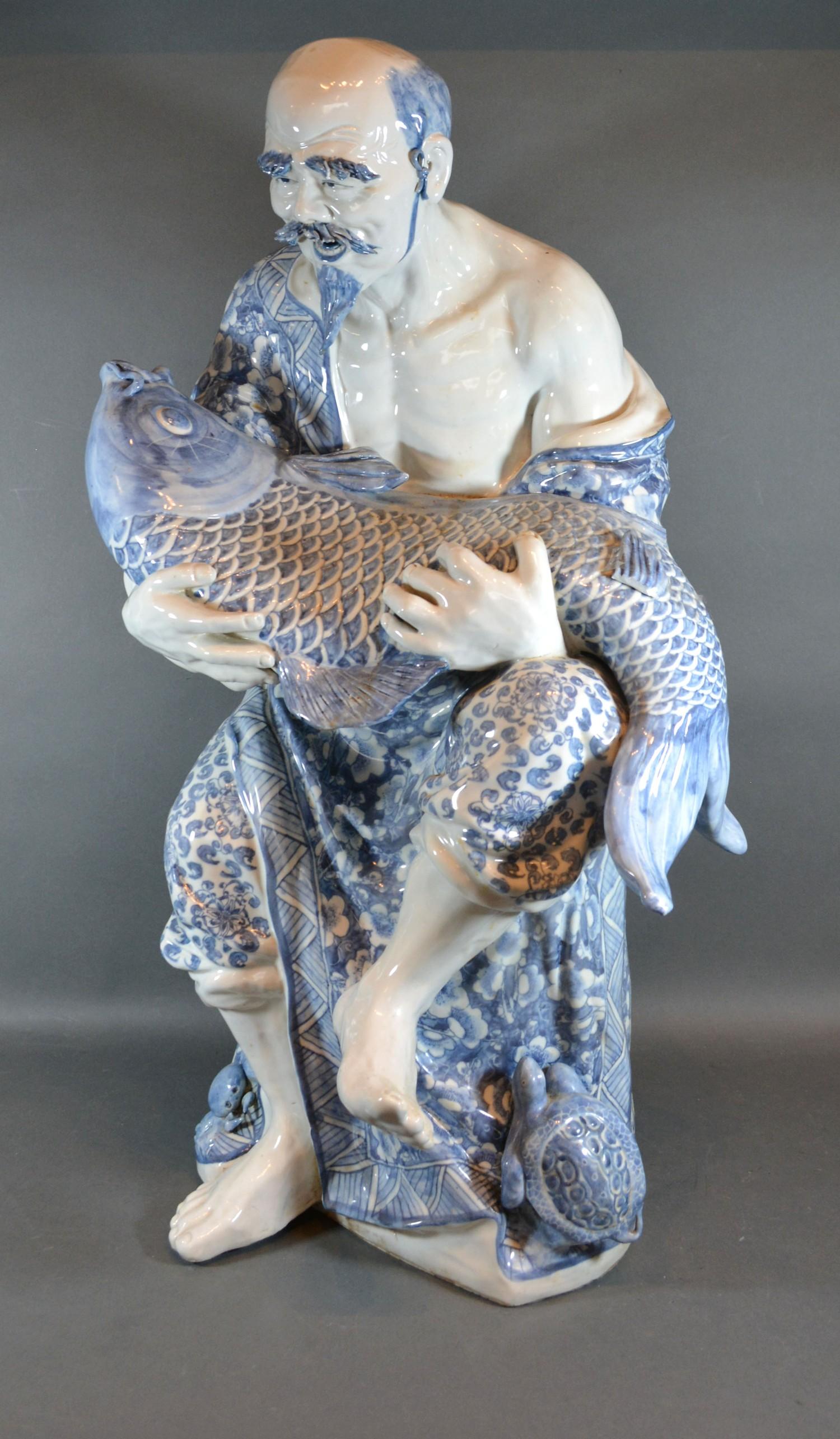 A Chinese Porcelain Underglaze Blue Decorated Figure Holding a Carp 68cm tall