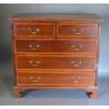 An Edwardian Mahogany Satinwood Inlaid Chest of two short and three long drawers with brass swan