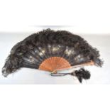 An Early 19th Century Carved Wooden Lace and Feather Fan with carved and pierced sticks and guards