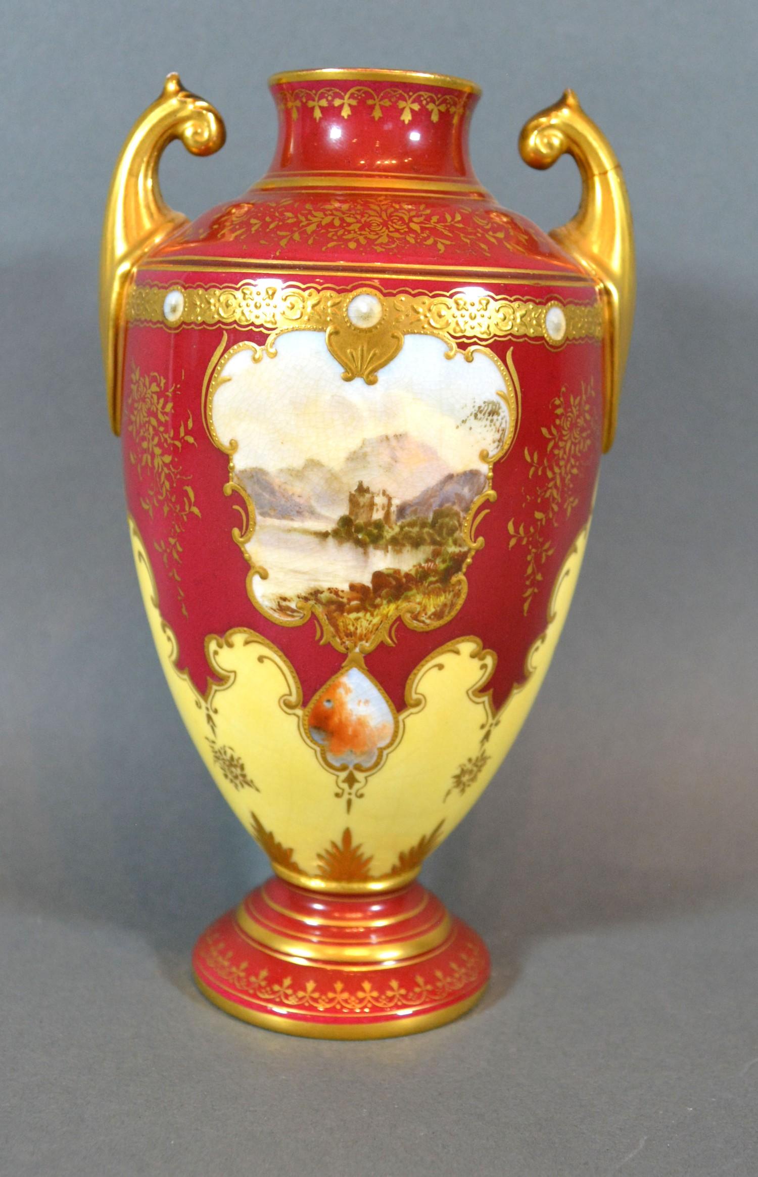 A Coalport Porcelain Two Handled Vase hand painted with a reserve upon a red and cream ground