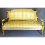 An Early 20th Century French Gilded Salon Sofa with an upholstered back and seat with scroll arms