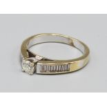 An 18ct White Gold Solitaire Diamond Ring, with diamond shoulders, approximately 0.10 ct. 3.2 grams,