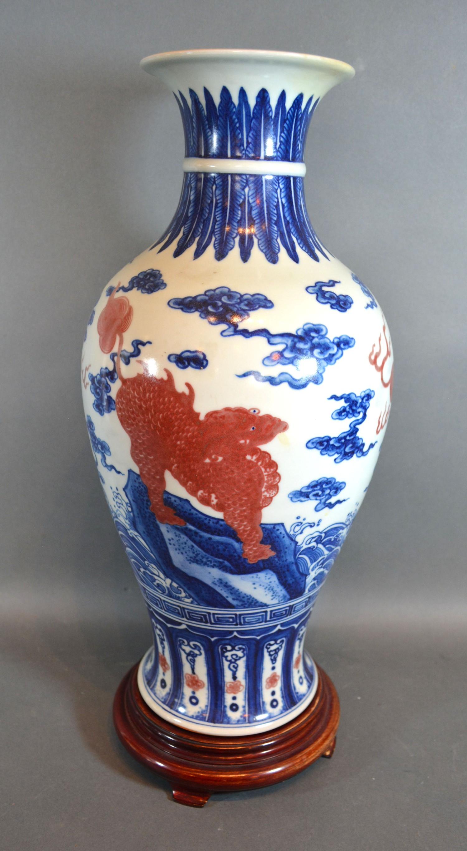 A Chinese Porcelain Oviform Vase decorated with iron red Fu dogs with underglaze blue six - Image 2 of 6