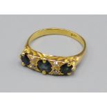 An 18ct Gold Sapphire And Diamond Ring, set with three Sapphire and four diamonds, 4 grams, ring