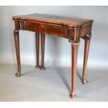 A George III Mahogany Card Table, the shaped hinged top above a plain frieze, raised upon turned