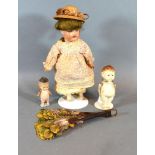 A Hubach Koppelsdorf Bisque Head Doll No. 302 with sleeping eyes and period dress together with