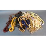 A Graduated Amber Bead Necklace together with a collection of other bead necklaces