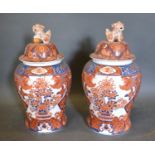 A Pair of Chinese Covered Vases decorated in iron red 49cm tall