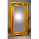A Large Rectangular Gilded Wall Mirror with scrollwork frame, 183 x 97 cms