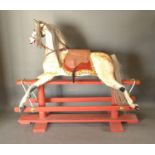 An Early 20th Century Large Dapple Grey Rocking Horse with mane upon a painted stand, 135 cms