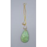 A Green Jade Pendant with 18ct. Gold Fine Chain