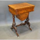 A Victorian Walnut Marquetry Inlaid Work Table, the hinged top above a frieze drawer with wool box