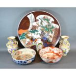 A Large Japanese Charger decorated with a Dragon and Figures within a Landscape, 45 cms diameter,