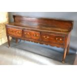 A George III Oak Dresser Base with a low galleried back above three drawers with brass swan neck