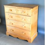 A Pine Chest, the moulded top above two short and three long drawers with knob handles raised upon