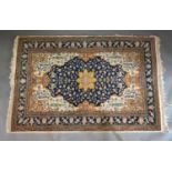 A North West Persian Woollen Rug with a central medallion within an all-over design upon a blue