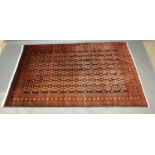 A North West Persian Woollen Rug with an all over design upon a red and blue ground within
