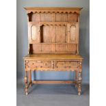 An 18th Century Style Oak Dresser, the boarded shelf back with two cupboard doors, the lower section