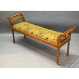 A 20th Century Window Seat with reeded ends above an upholstered seat upon barley twist legs,