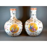 A Pair of Chinese Bottleneck Large Vases each hand painted with reserves depicting figures amongst