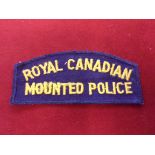 Royal Canadian Mounted Police Cloth Shoulder Title (yellow thread on blue backing)