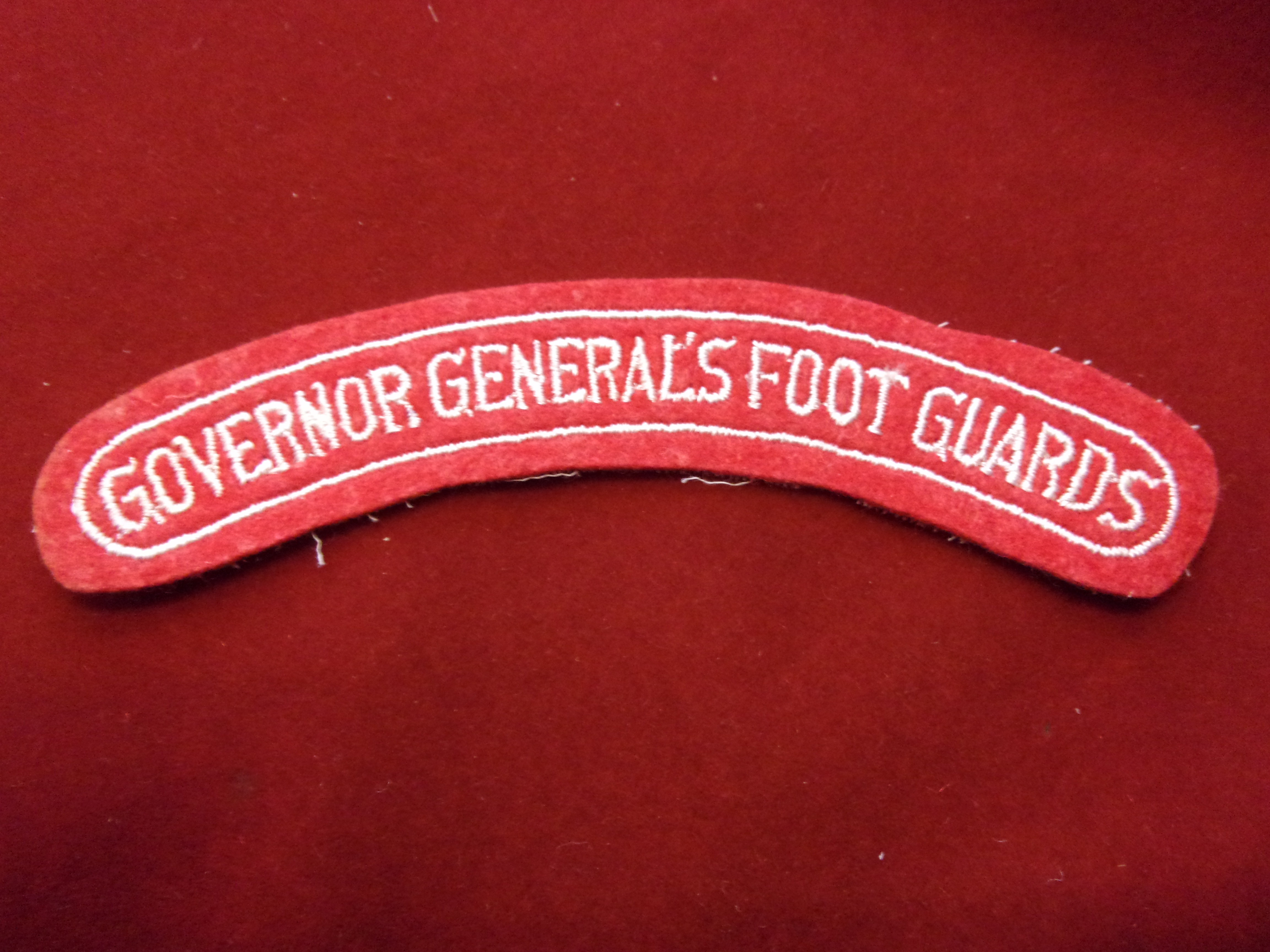 Canadian Governor General's Foot Guards cloth shoulder title, white on red.