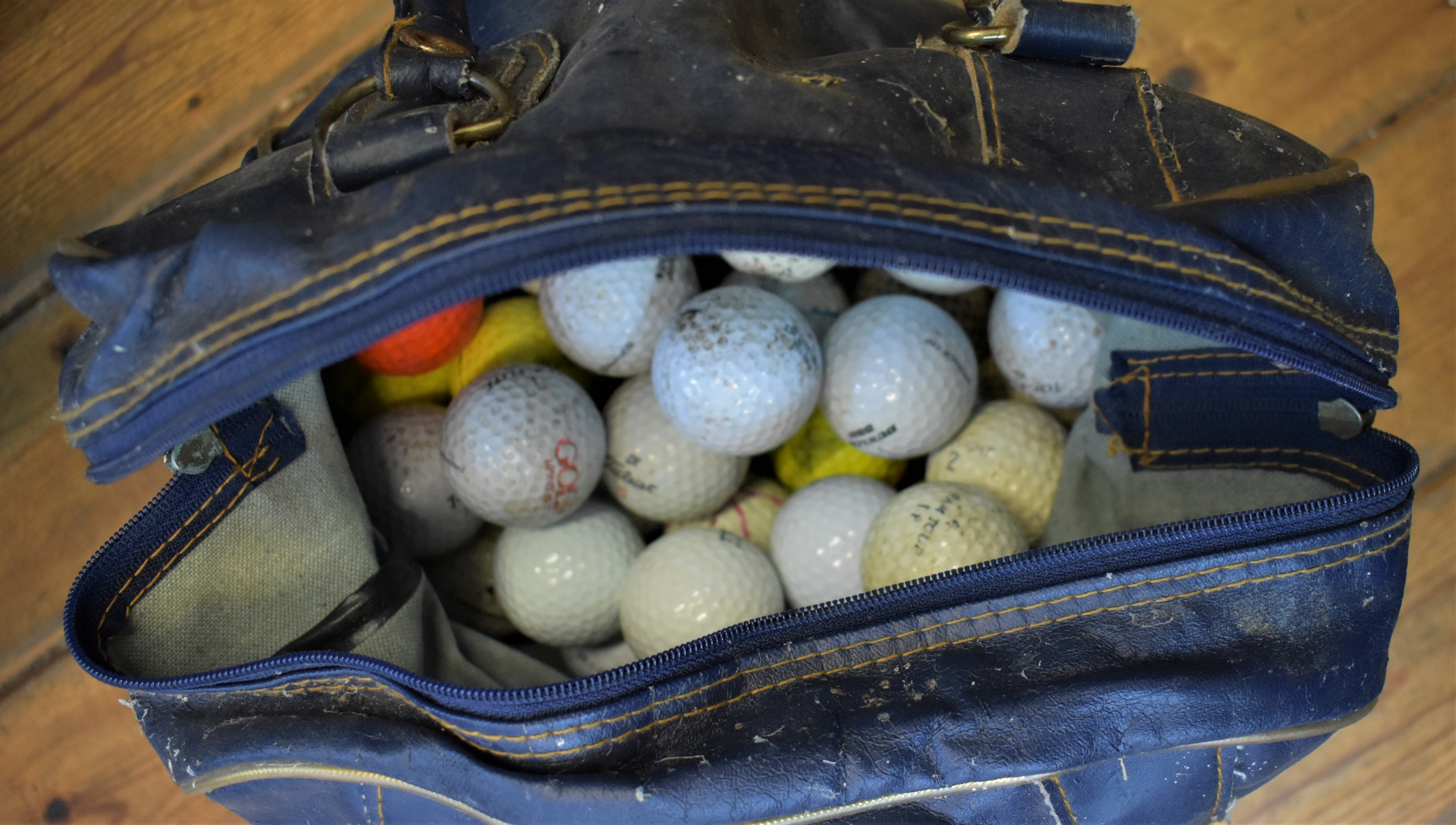A nice pair of carry cases filled with used golf balls. Nice used condition