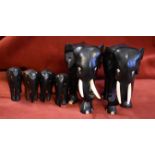 Elephants-all hard wood, a pair approx. 5" tall, bone tusks, and four smaller, approx. 2.1/2" tall